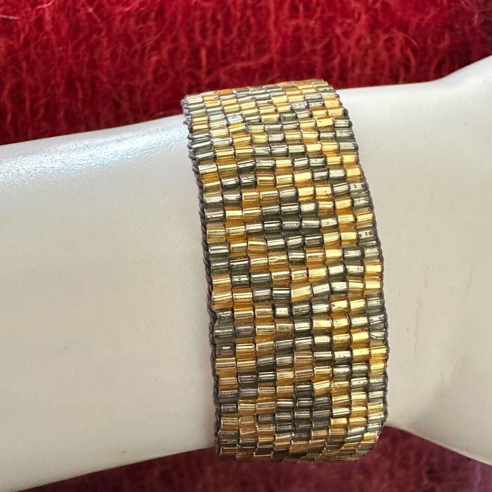 Gold tone and grey beaded tassel adjustable bracelet